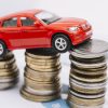 small-red-car-stack-increasing-coins